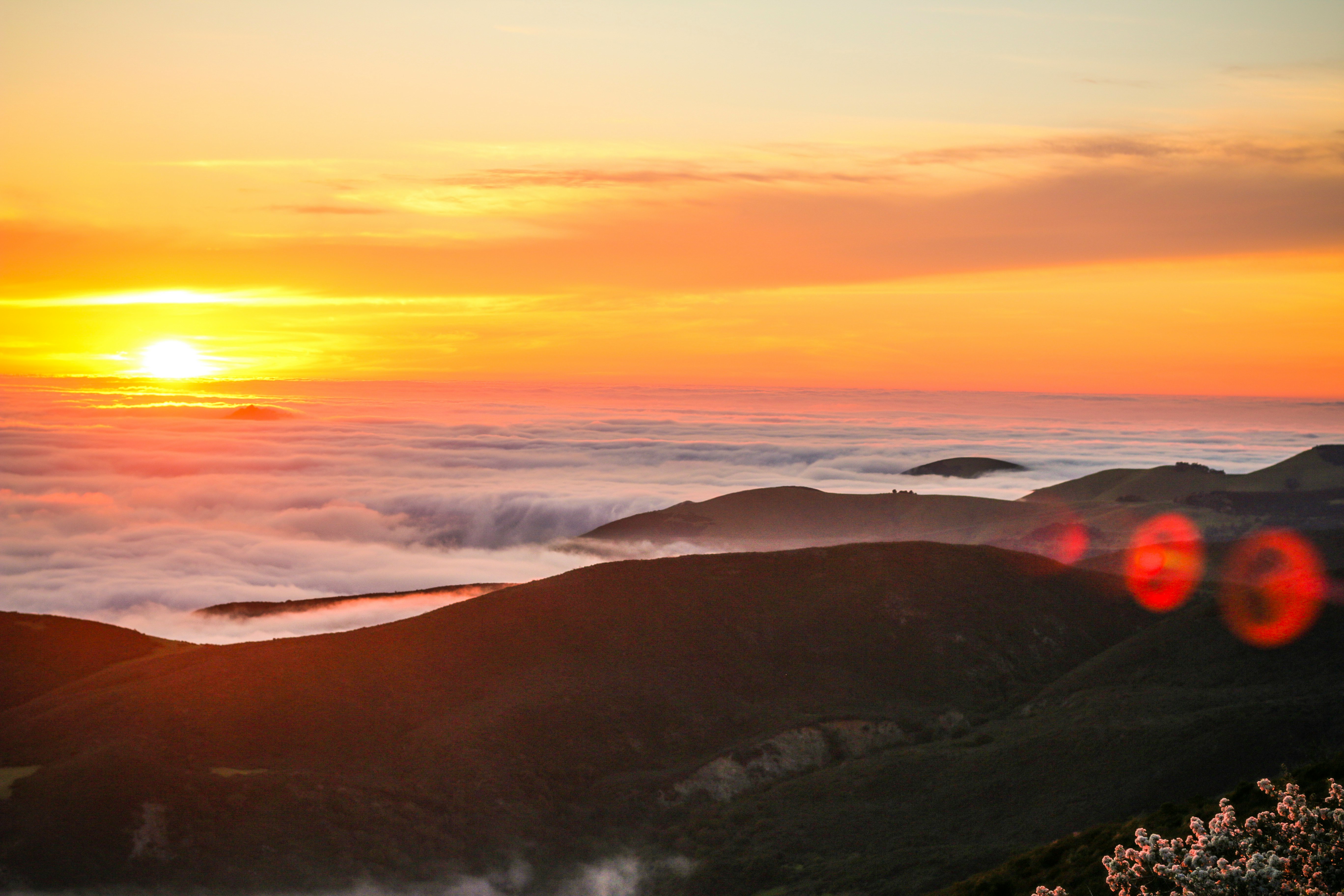 sun over the clouds and hill